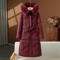 Manteau d’hiver long matelassé pour femme avec capuche en fausse fourrure et ceinture